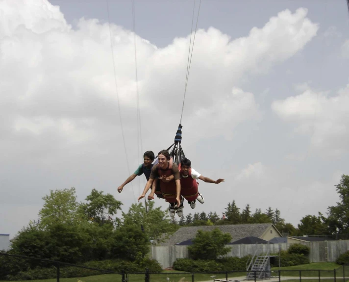 people are attached to ropes to go up and down