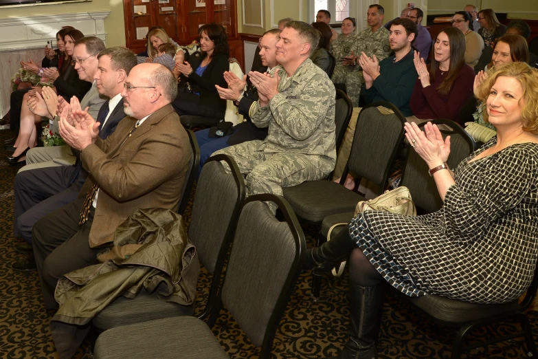 group of military personnel applauding themselves in hall