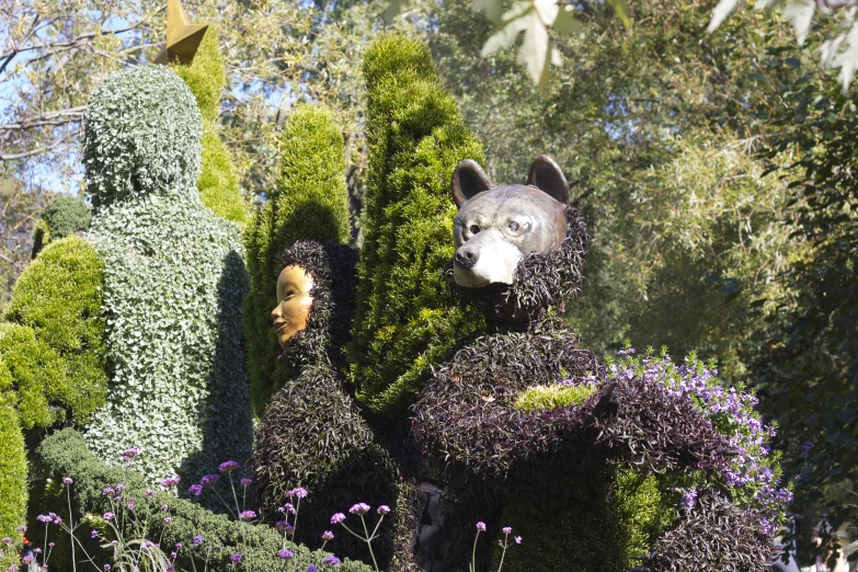 sculptures in the shape of animals and plants in a garden