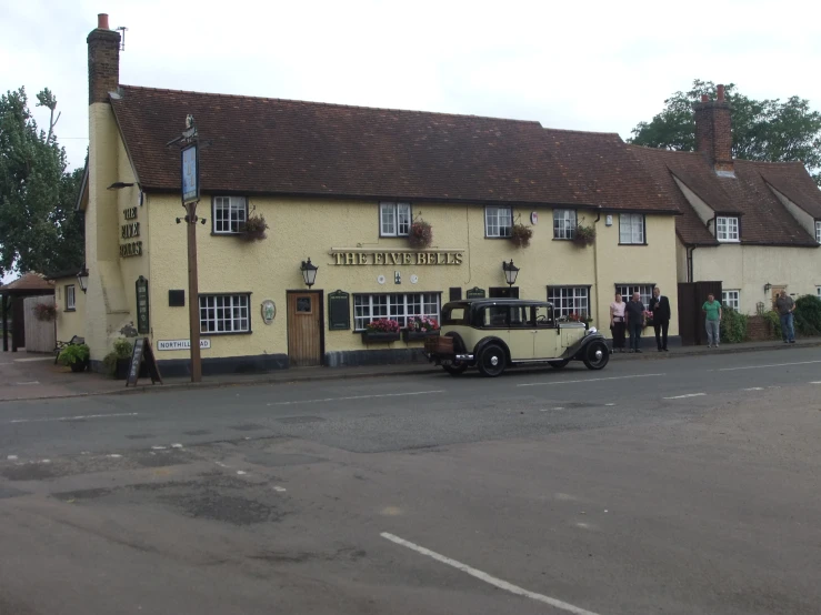 two men are standing outside of the white horse in suffolk