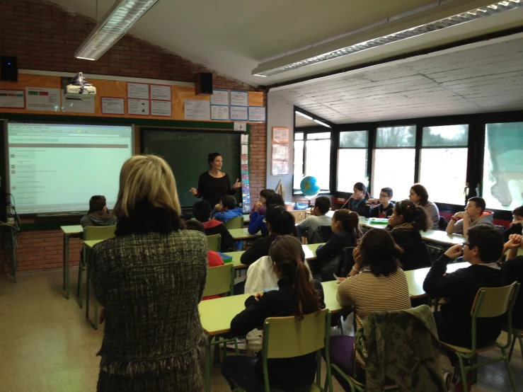 an audience in a class room watching a male lecturer