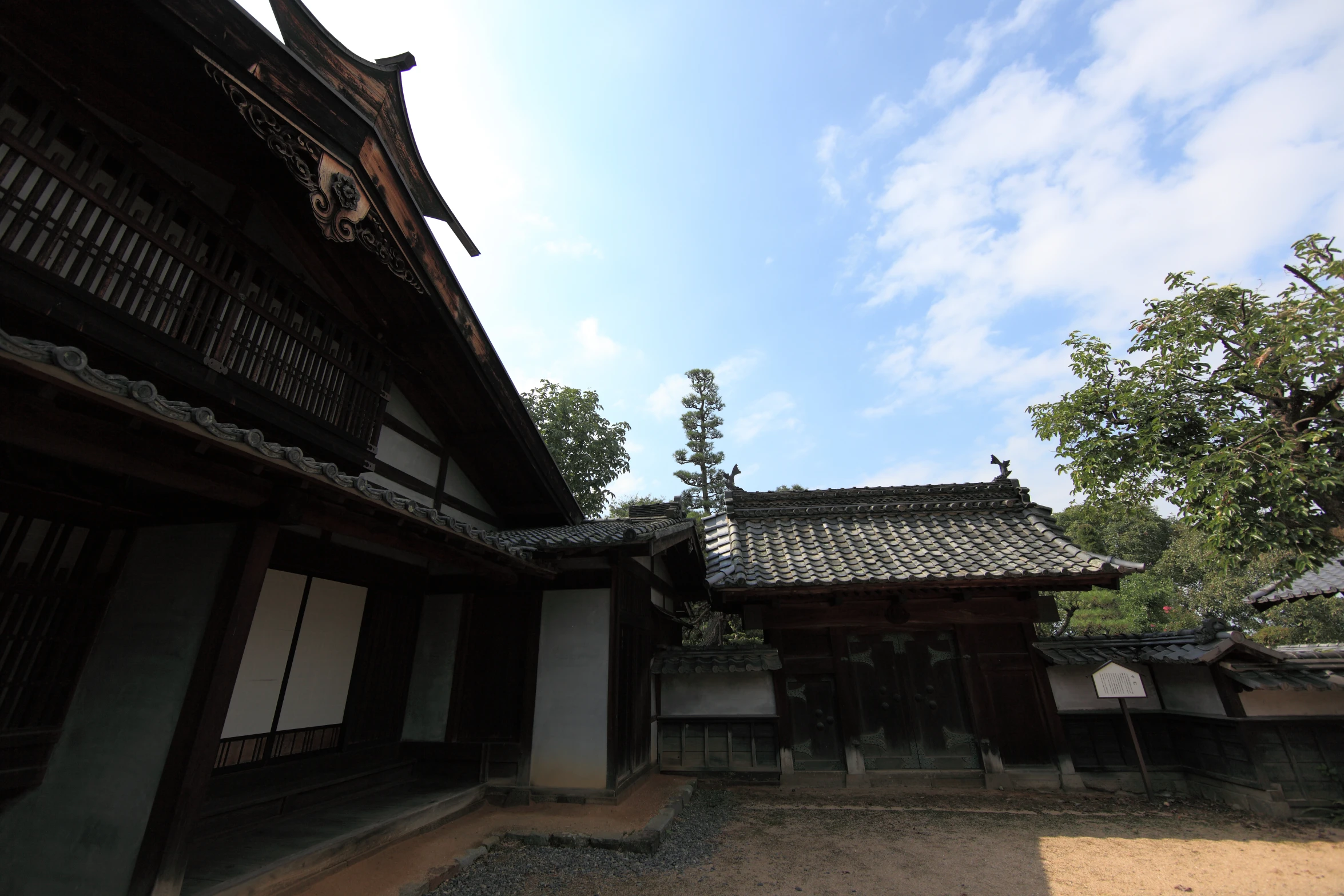 an old wooden house next to some trees