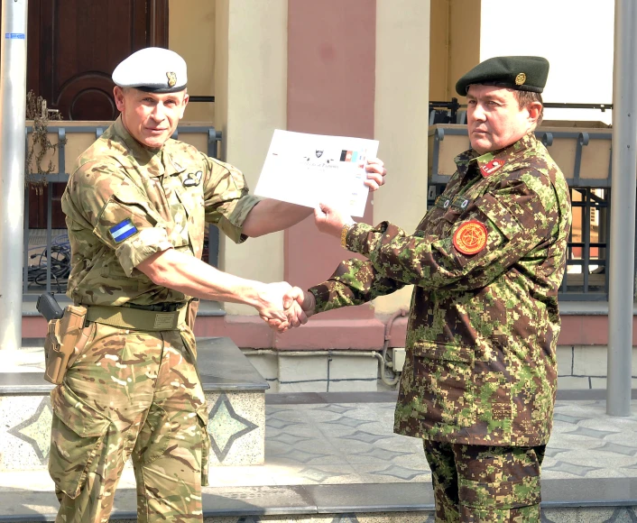 two men in military uniforms shaking hands