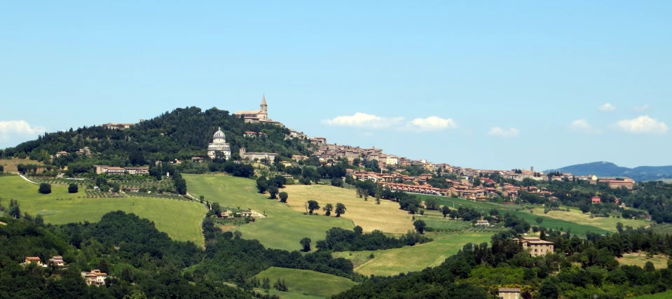 an aerial view of a mountain town with trees on the hillside