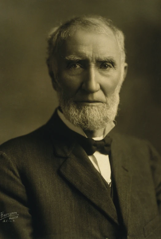 an old time gentleman wearing a suit and bow tie