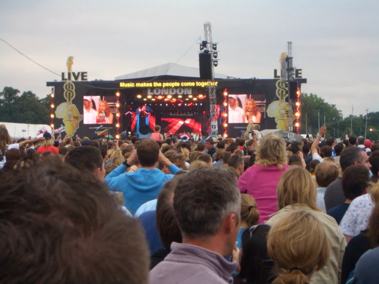 a crowd of people standing at a stage