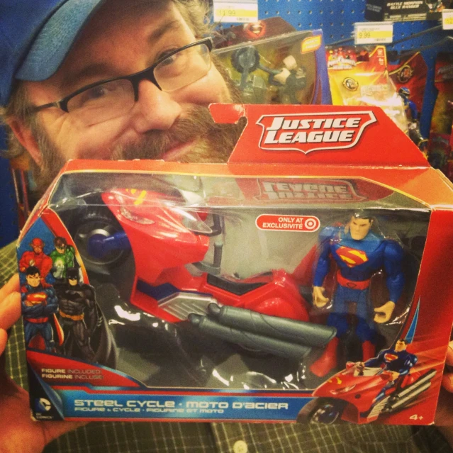 the man has an open box with superman action figures