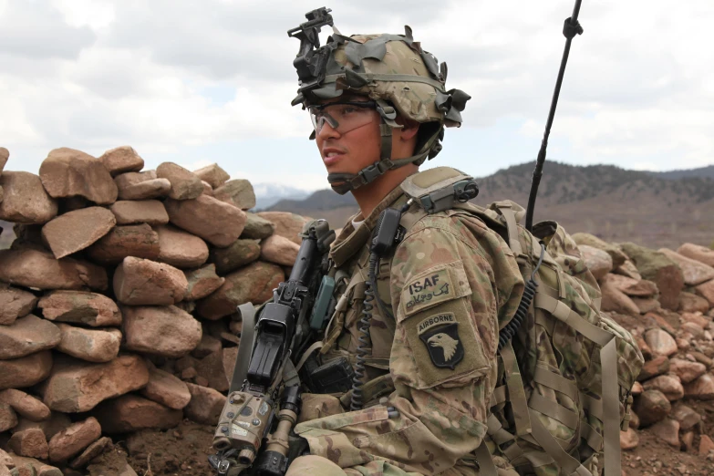 a soldier is holding an akm while looking at his phone