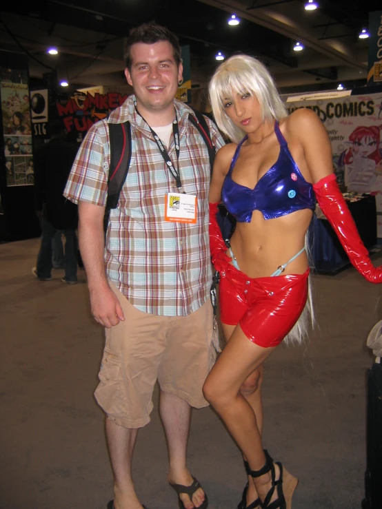 a man and a woman wearing  costumes pose for a picture