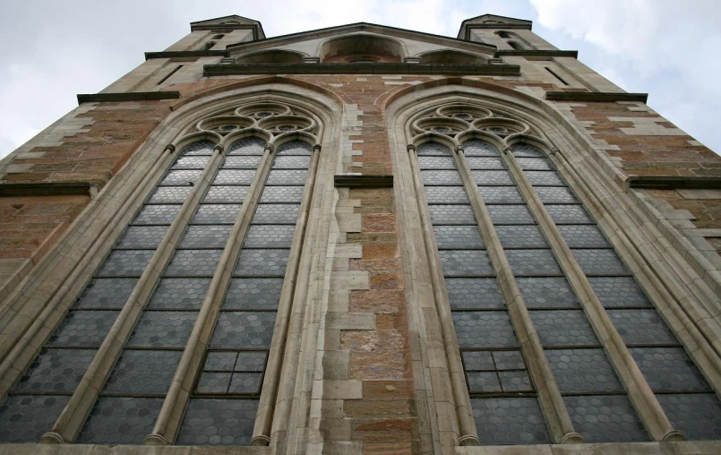 a very tall brick cathedral with stained glass windows