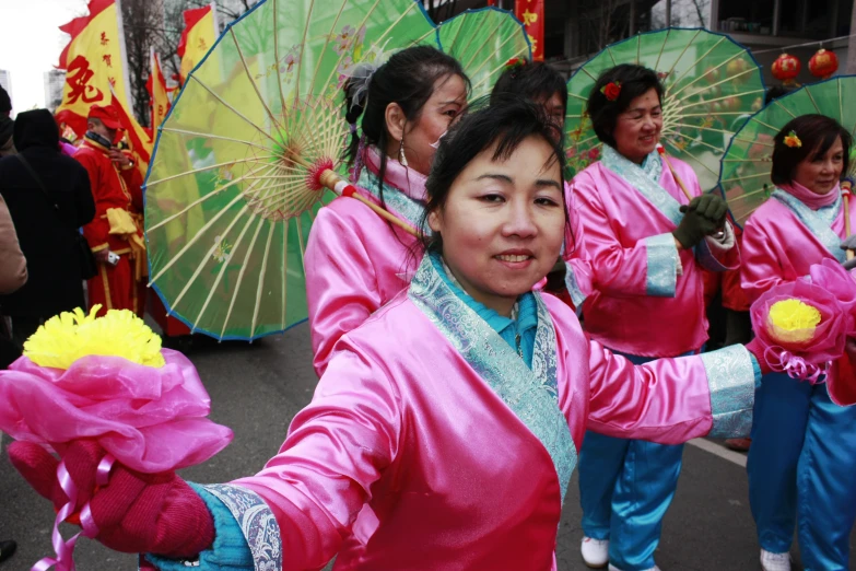 a woman is dressed in pink in a parade