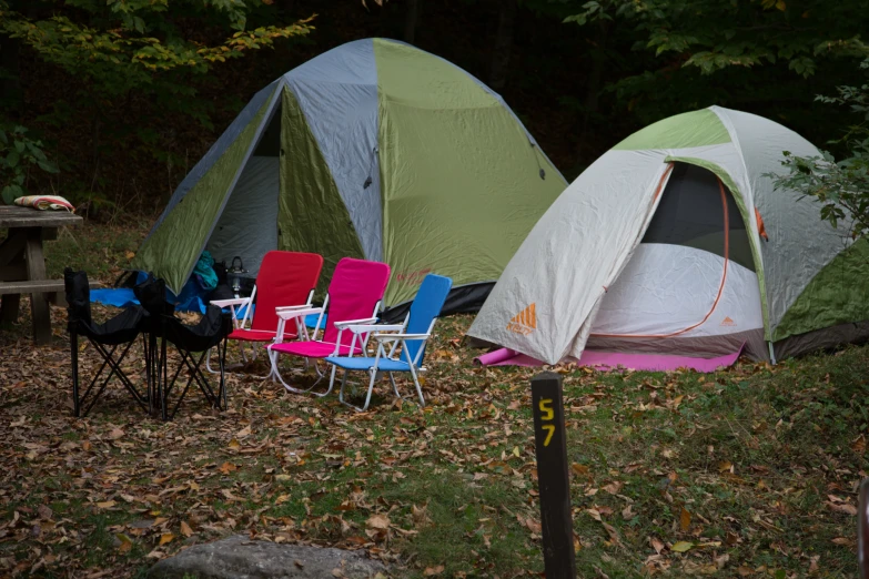 two tents set up next to some colorful chairs