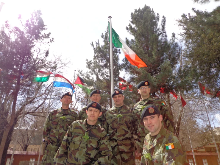 group of army men in uniforms posing for the camera