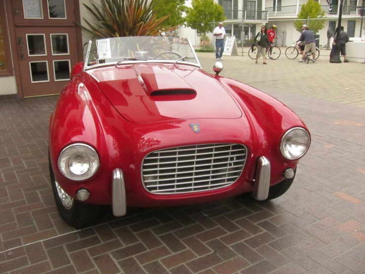 a red sports car parked in front of a building