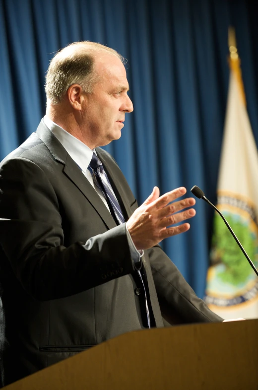 an official is speaking on the stage at a podium