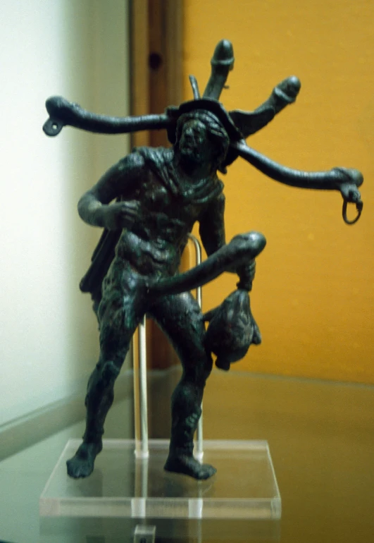 an antique statue of a man carrying an infant in his arms