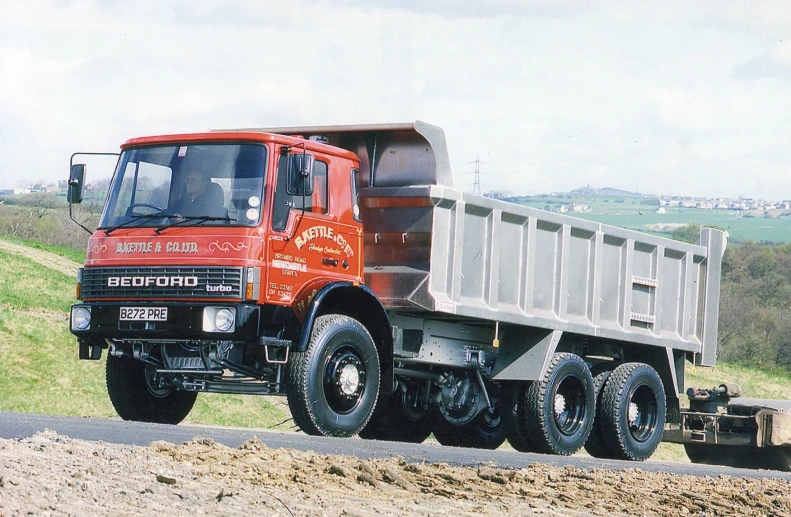 a big red truck driving down the road