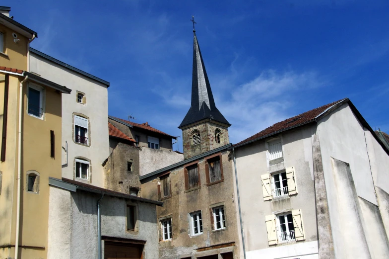 a church steeple stands above some buildings