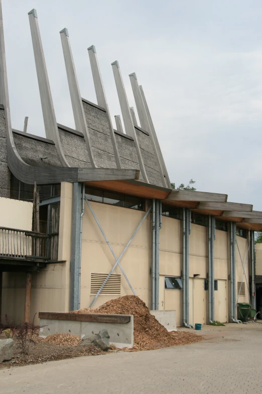 a parking garage with steel beams sticking out from it