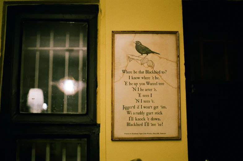 a sign is attached to the wall above the window