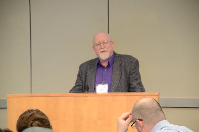 man standing in front of an audience in the conference room