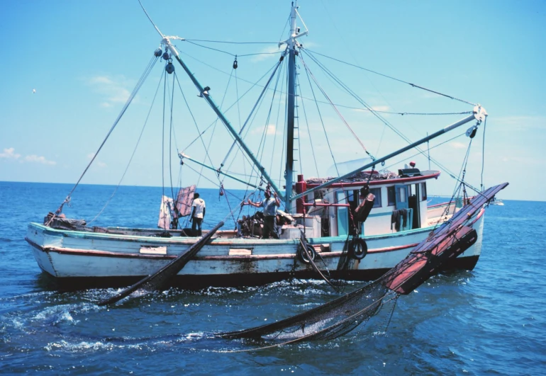 a white boat in the middle of the ocean