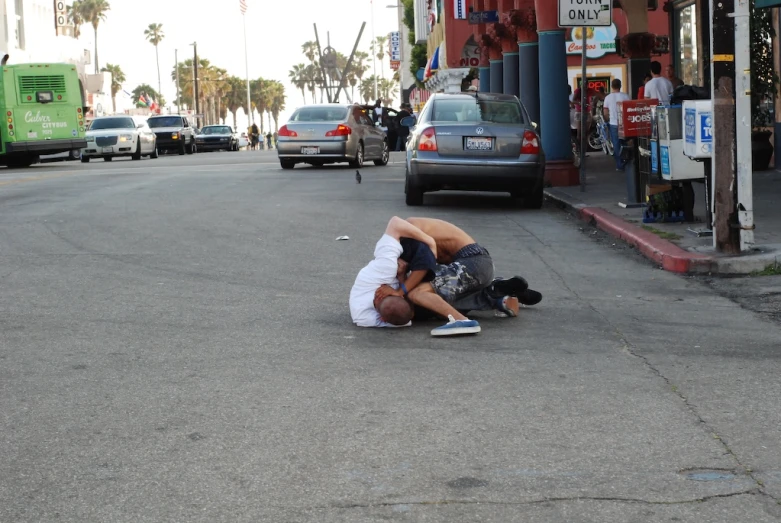 a  is on his knees while he plays in the street