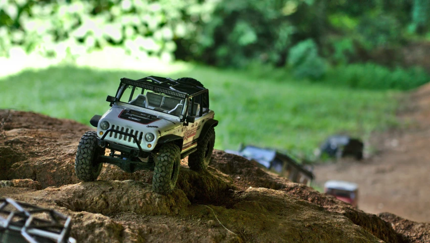 a jeep parked on top of a rock in the dirt