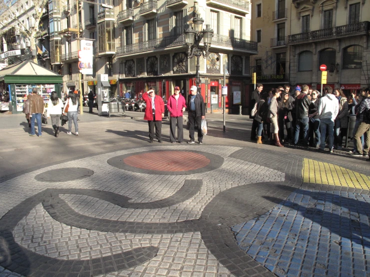 a group of people that are standing near a building