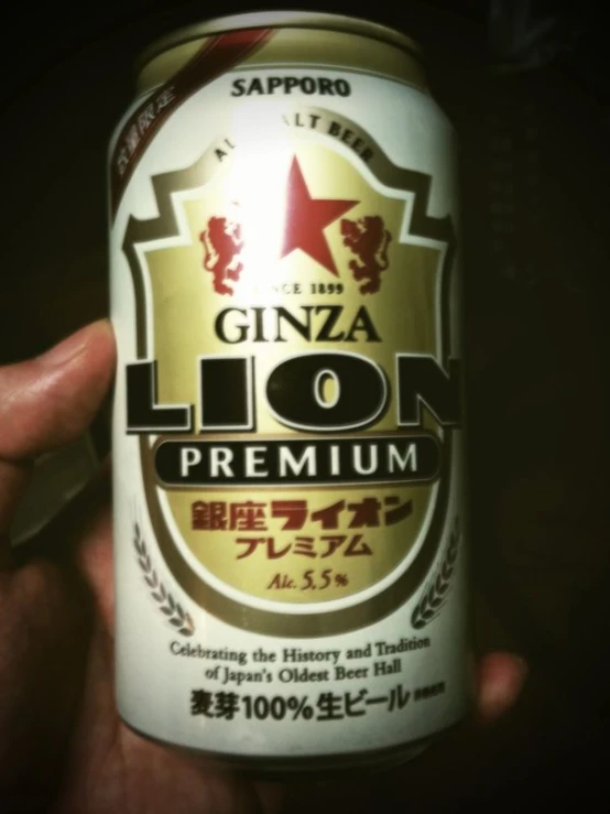 the can of a lion beer is displayed in front of a dark background