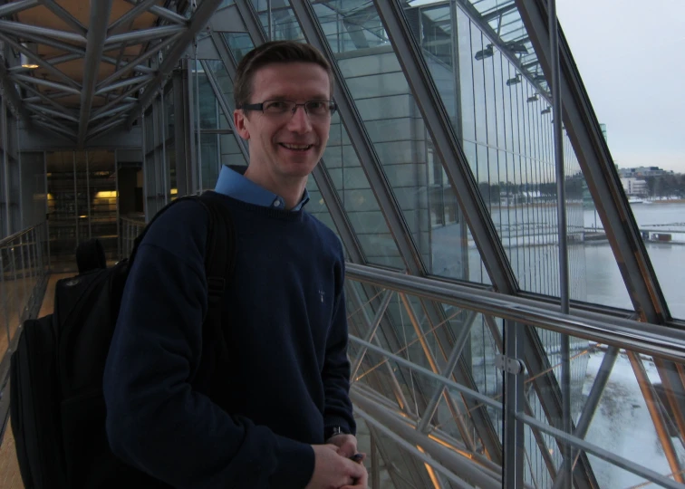 a man in a blue sweater and dark glasses