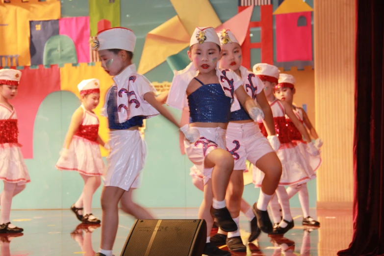 several little girls dressed up in costume with instruments