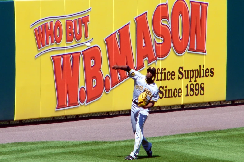 a baseball player is throwing a ball while standing on a field