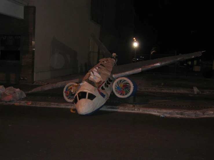 a pair of tennis shoes on the ground and with wheels crashing