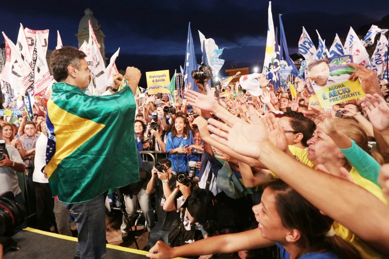 a man holding his arms in the air as people watch