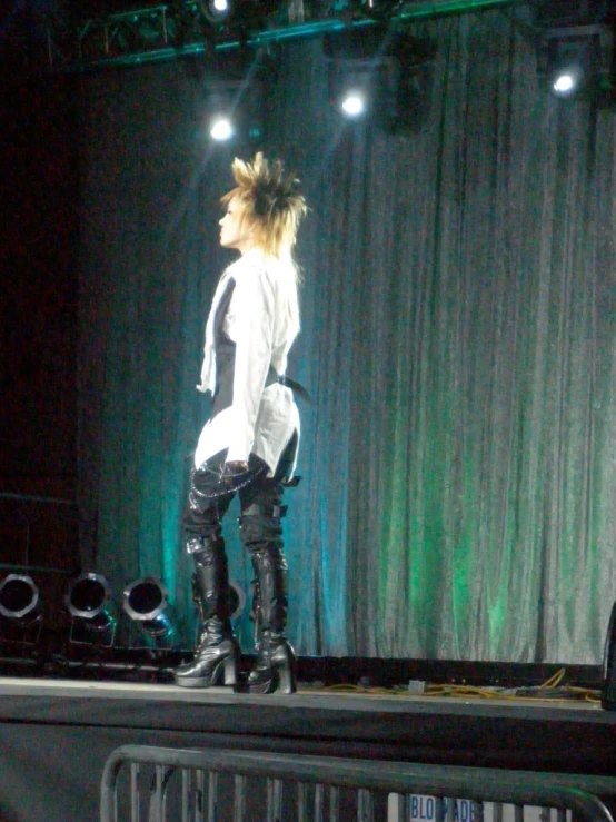 a woman with a ponytail standing on top of a stage