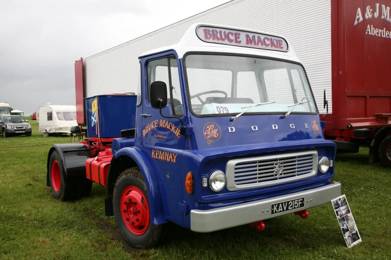 a blue tractor sitting on top of grass covered field