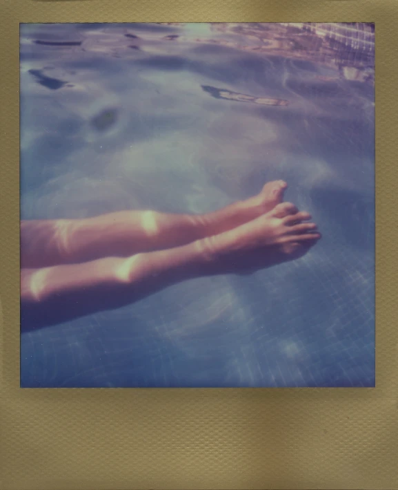 a person with bare legs in a swimming pool