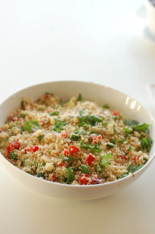 a bowl of food with rice, vegetables, and other veggies