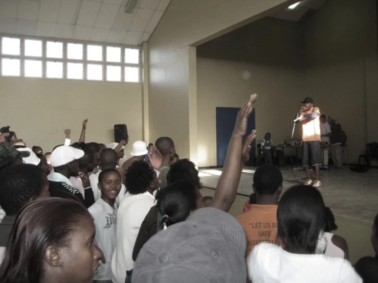 a man is standing on a stage in front of a crowd