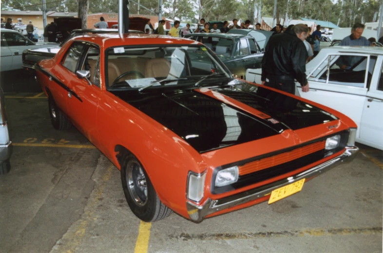 a car sitting in a showroom surrounded by other cars