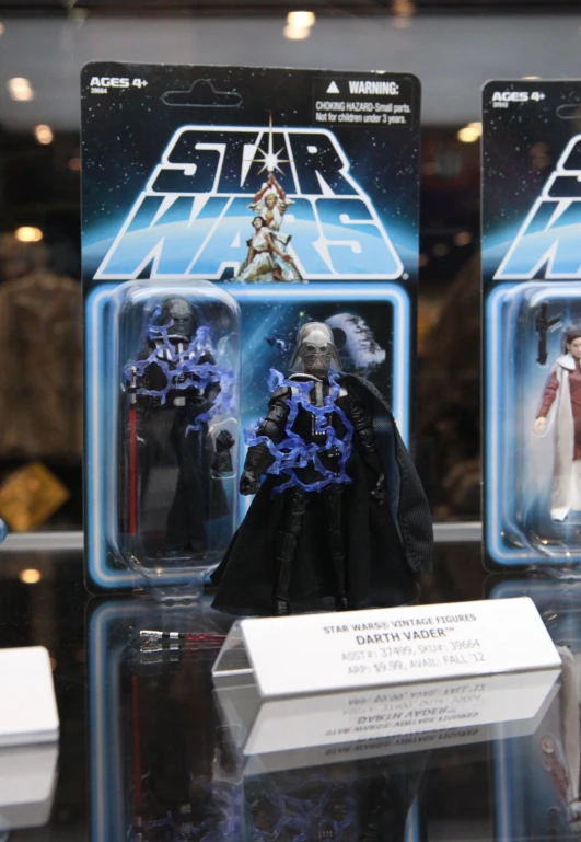 a pair of action figures on display in a glass case