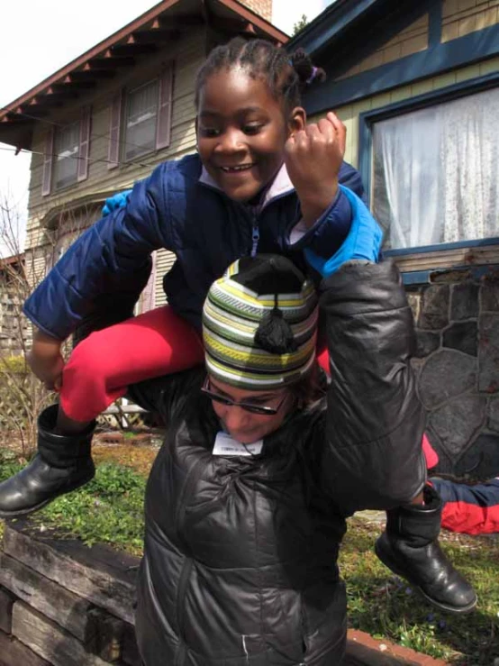 a woman with a child sitting on her shoulders