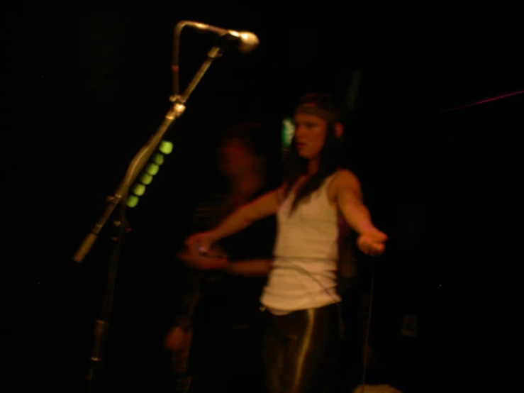 two people performing at a dark stage