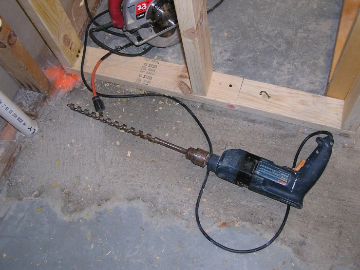 an electric power drill in a box with other tools