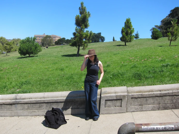 a woman in jeans with suitcases on the ground