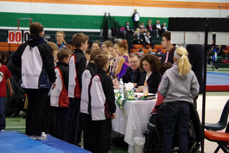 there are several people standing at a table