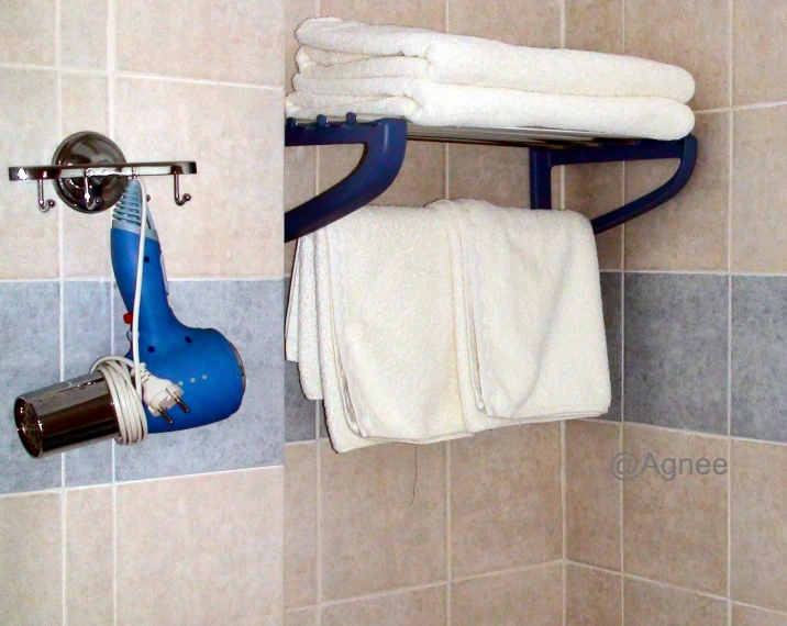 a bathroom with a tub, shower head and several towels