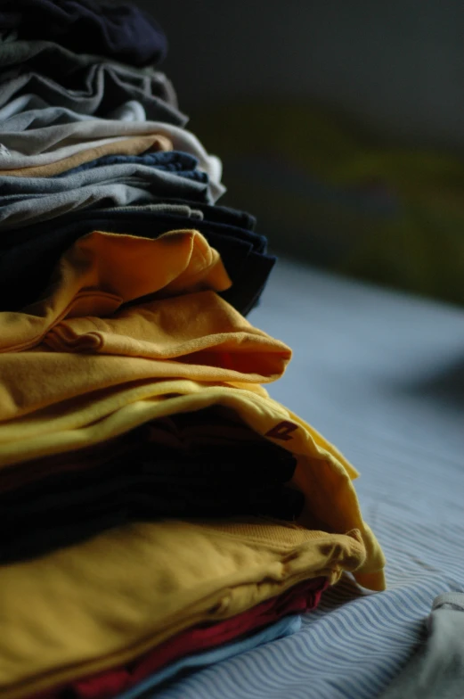 a stack of folded shirts sitting on top of each other