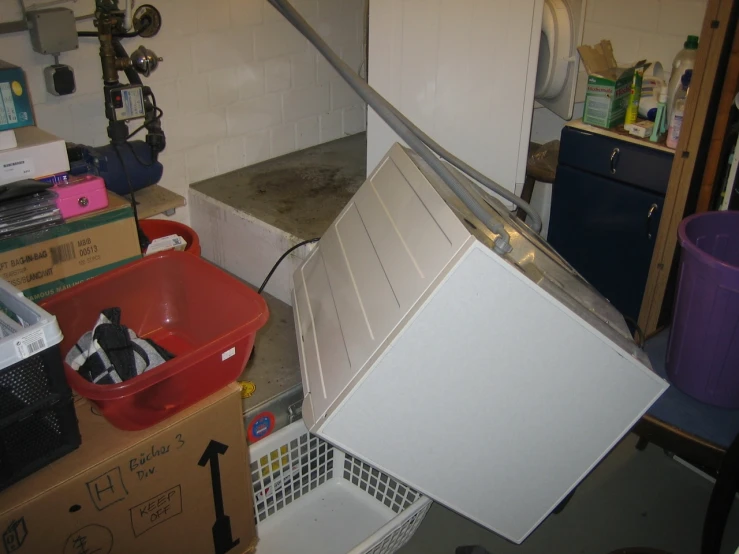 the kitchen is cluttered with items and items left out